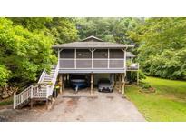 Unique home featuring a screened porch and convenient drive-under parking at 4144 Fairport Rd, Kittrell, NC 27544