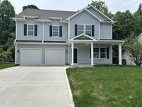 Charming two-story home with gray siding, blue shutters, and a two-car garage at 431 Mayview Dr, Creedmoor, NC 27522