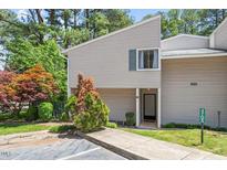 Inviting townhouse featuring neutral siding, manicured landscaping, and a welcoming entrance at 4705 Walden Pond Dr # 110-C, Raleigh, NC 27604
