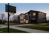 Modern home featuring a two-tone color scheme, well-manicured lawn, and attractive architectural design at 500 Grigsby Ave, Holly Springs, NC 27540