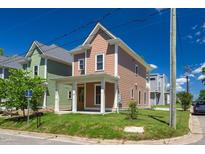 Charming two-story home with a front porch, manicured lawn, and inviting curb appeal at 500 Spruce St, Durham, NC 27703