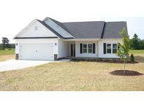 Charming single-story home boasts a white exterior, attached garage, and a well-manicured lawn at 614 Tart Town Rd, Dunn, NC 28334