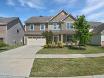 Charming two-story home with a well-manicured lawn, inviting entrance, and two car garage at 617 Hiddenbrook Dr, Durham, NC 27703