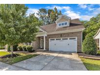 Charming brick home with a two-car garage, landscaped yard, and a welcoming front entrance at 736 Varina Ln, Fuquay Varina, NC 27526