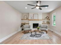 Inviting living room features a fireplace with decorative mantle and floating shelves at 847 E Maple Ln, Fuquay Varina, NC 27526