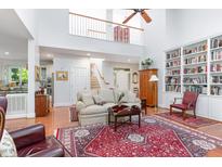 Bright living room boasts hardwood floors, high ceilings, and built-in bookshelves for ample storage and sophisticated appeal at 850 N Langdon, Pittsboro, NC 27312