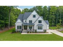 Beautiful two-story home featuring a manicured lawn, neutral color palette, and a welcoming front porch at 91 Ivy Ridge Rd, Chapel Hill, NC 27516