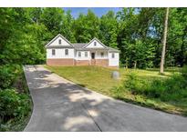 Charming two-story home with a well-manicured lawn, and a concrete driveway at 10304 Stallion Way, Bahama, NC 27503