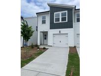 Charming townhome featuring a one-car garage, modern design, and freshly landscaped front yard at 1116 Merlot Hills Ln, Durham, NC 27704
