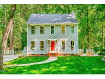 Charming two-story home with a bright red front door and landscaped front yard at 114 Bonaparte Dr, Hillsborough, NC 27278