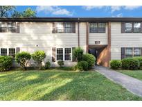 Inviting condo featuring tidy landscaping, charming shutters, and clearly marked unit numbers at 1208 Manassas Ct # A, Raleigh, NC 27609