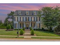 Stately two-story home with black shutters, covered porch, manicured lawn, and inviting curb appeal at 12500 Richmond Run Dr, Raleigh, NC 27614