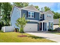 Charming two-story home featuring a two-car garage and well-manicured lawn at 128 Potomac River St, Garner, NC 27529