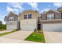 Charming townhomes with attached garages, manicured lawns, and traditional design elements at 136 Ashlar Ct, Cary, NC 27519