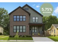 Charming two-story home featuring a mix of brick and siding, with a well-manicured lawn at 1405 Watts St, Durham, NC 27701