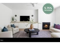 Bright living room with modern fireplace, plush seating, and built-in media center at 1405 Watts St, Durham, NC 27701