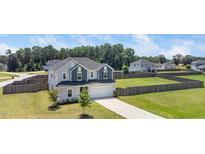 Charming two-story home with a two-car garage, landscaped yard, and a spacious fenced backyard at 171 Piney Field Rd, Fuquay Varina, NC 27526
