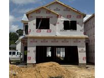 New two-story house under construction with visible framing and a two-car garage at 184 W Allen St, Four Oaks, NC 27524
