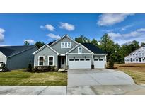 Charming two-story home featuring a three-car garage and manicured front lawn at 2313 Abbeyhill Dr # 3, Raleigh, NC 27610