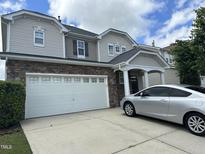 Charming two-story home featuring a two-car garage, stone accents, and classic architectural design at 3124 Mackinac Island Ln, Raleigh, NC 27610