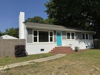 Charming single-story home featuring a bright blue front door and brick steps at 3804 Cobb St, Garner, NC 27529