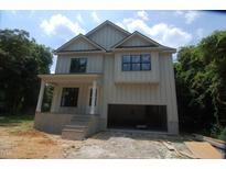 An in-construction, two-story home featuring a two-car garage, light siding, and a covered front porch at 4109 Stonewall Dr, Raleigh, NC 27604