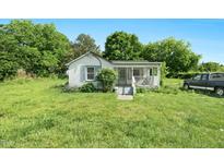 Charming cottage-style home with a covered front porch and large yard at 441 Cedar St, Henderson, NC 27536