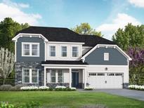 Charming two-story home featuring stone accents, blue shingles, black roof, white trim, and a well-manicured lawn at 5000 Trotter Dr, Raleigh, NC 27603