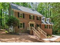 Beautiful two-story brick home with manicured front yard and inviting entrance staircase at 5125 Penny Rd, Raleigh, NC 27606