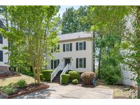 Charming two-story home with a well-manicured front yard, complimented with trees at 6 Weathergreen Ct, Durham, NC 27713