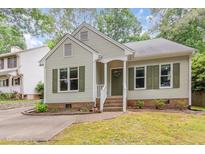 Charming home featuring a well-maintained yard and inviting front porch at 6004 Volant Dr, Raleigh, NC 27609