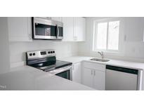 Bright kitchen featuring stainless steel appliances, modern cabinets, and a quartz countertop at 800 Pritchard Avenue Ext # H4, Chapel Hill, NC 27516