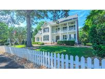 Charming two-story home with a manicured front yard and white picket fence creating an inviting curb appeal at 8042 Hogan Dr, Wake Forest, NC 27587