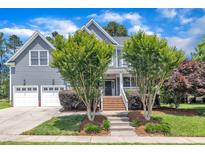 Charming two-story home featuring a manicured lawn, attached garage and classic architectural details at 805 Alden Bridge Dr, Cary, NC 27519