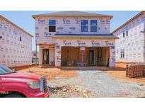 New home under construction with Tyvek HomeWrap, showcasing progress with visible framework and future home layout at 840 Ottawa Dr, Garner, NC 27529