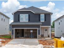 Two-story home featuring a 2-car garage, gray siding, and black shutters, offering modern curb appeal at 845 Ottawa Dr, Garner, NC 27529