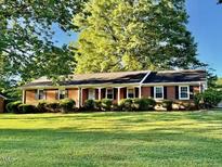 Charming single-story brick home with a well-maintained front yard at 1005 Driftwood Dr, Siler City, NC 27344