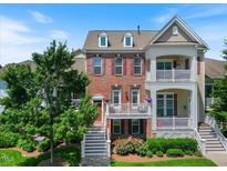 Charming two-story home with brick facade, double balconies and well-manicured landscaping at 10520 Sablewood Dr # 103, Raleigh, NC 27617