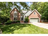 Charming two-story home featuring a brick facade, light green siding, and a well-manicured lawn at 108 Hanover Pl, Chapel Hill, NC 27516