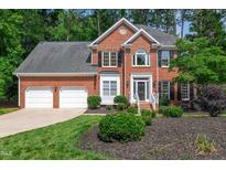 Charming two-story brick home with manicured lawn and attached two-car garage, beautiful curb appeal at 110 Glenrose Ln, Cary, NC 27518