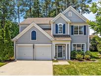 Charming two-story home with blue shutters and a well-manicured front yard, complemented by a two-car garage at 110 Huntersville Rd, Morrisville, NC 27560