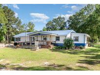 Charming single-story home with blue metal roof and covered front porch at 155 G Herring Rd, Princeton, NC 27569