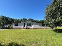 Charming single-story home with spacious yard and a covered front porch at 165 Dawn Rd, Benson, NC 27504
