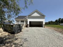 New construction featuring a white exterior and a two-car garage, set on a gravel lot at 168 Clayton Rd, Princeton, NC 27569