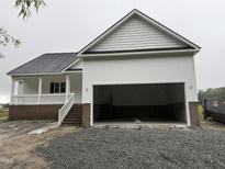 New home featuring a spacious two-car garage with carriage doors and traditional architecture at 168 Clayton Rd, Princeton, NC 27569