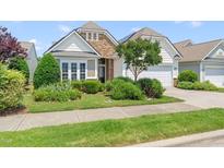 Charming home showcasing stone accents, manicured landscaping, and inviting curb appeal at 204 Dowington Ln, Cary, NC 27519