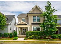 Charming two-story home with a welcoming front porch and manicured landscaping at 249 Salt Cedar Ln, Chapel Hill, NC 27516