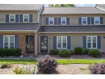 Charming townhouse exterior with blue shutters and well-maintained landscaping at 2519 Hitchcock Dr, Durham, NC 27705