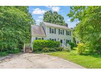 Charming two-story home with a well-maintained lawn and mature trees at 3 Cobble Glen Ct, Durham, NC 27713