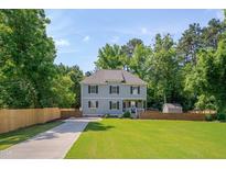 Charming two-story home featuring a manicured lawn, classic design, and inviting curb appeal at 3003 University Dr, Durham, NC 27707